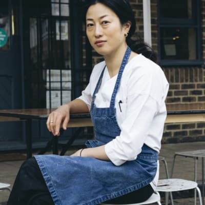 Chef Shuko Oda wearing chef whites and blue apron outside Koya Ko in Broadway Market. Photo by Sirui Ma