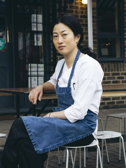 Chef Shuko Oda wearing chef whites and blue apron outside Koya Ko in Broadway Market. Photo by Sirui Ma