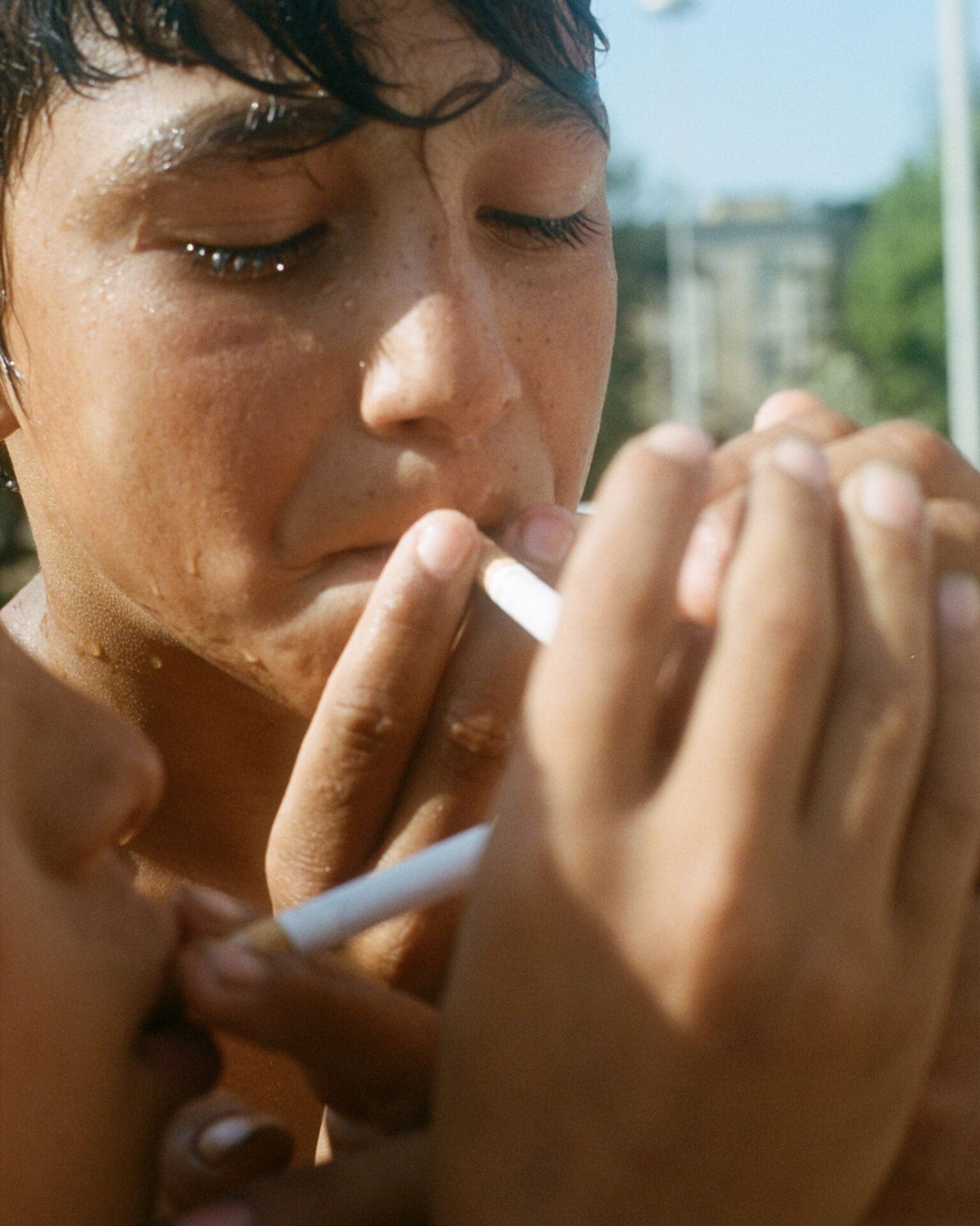 Hazel Gaskin photographs Albania | a photo of a young boy smoking in Tirana