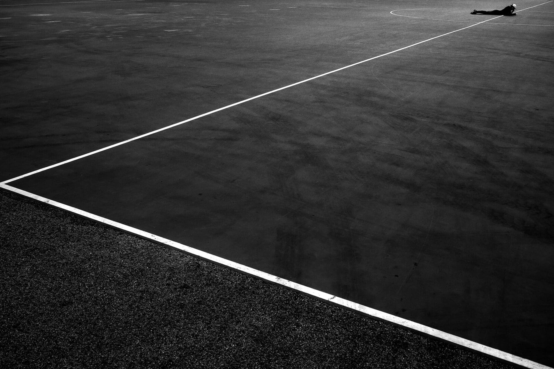 Jason Au | In Hong Kong's Victoria Park, a very prominent L-shaped marking on a football pitch is pointing towards a relaxed guy lying at the centre circle