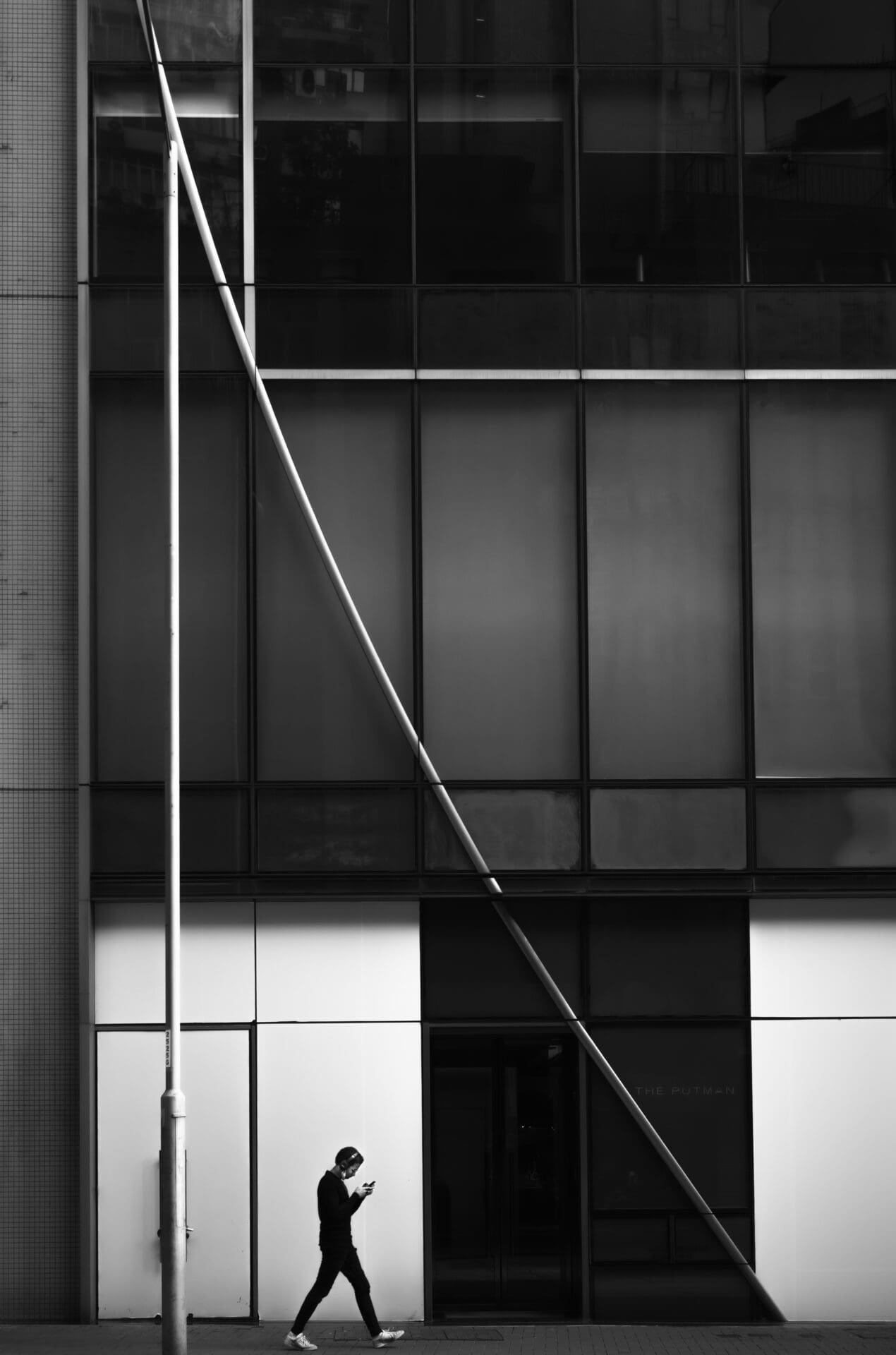 Jason Au | A photo of a triangle architectural element on a gridded building facade in Hong Kong