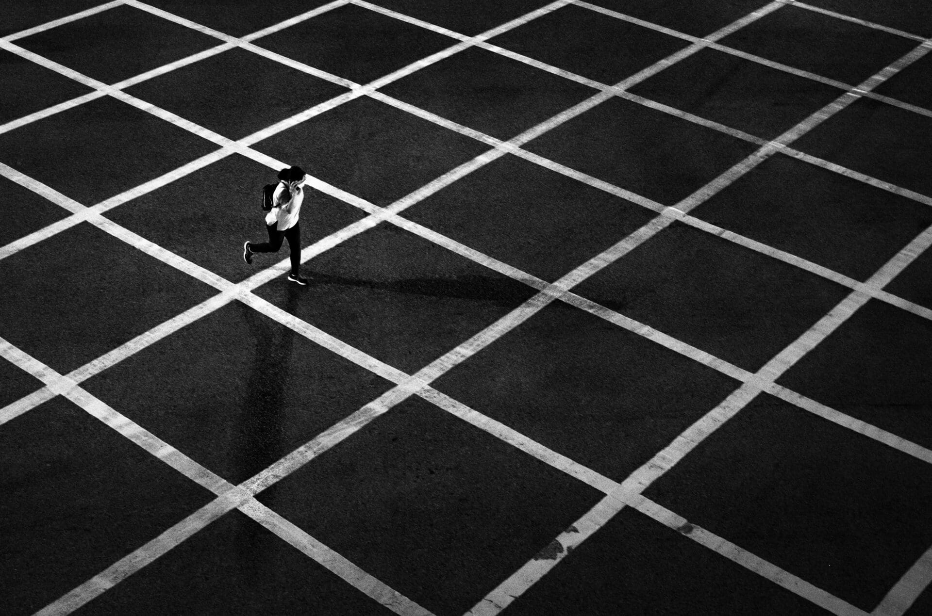 Jason Au | In Central Hong Kong, a person crosses a box junction in a hurry while still managing to speak on the phone