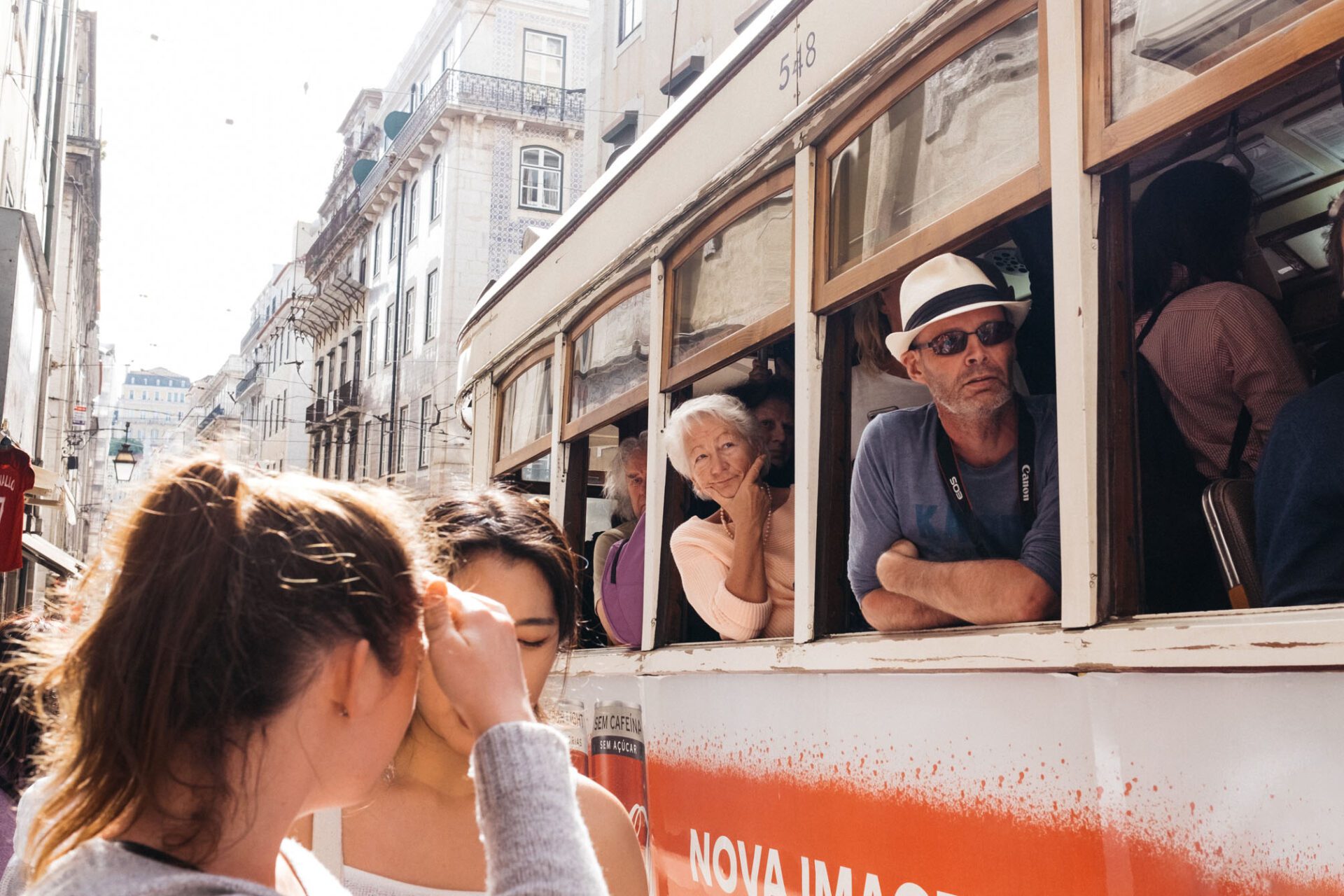 People looking out a bus on a busy street in Lisbon by photographer Emma Croman