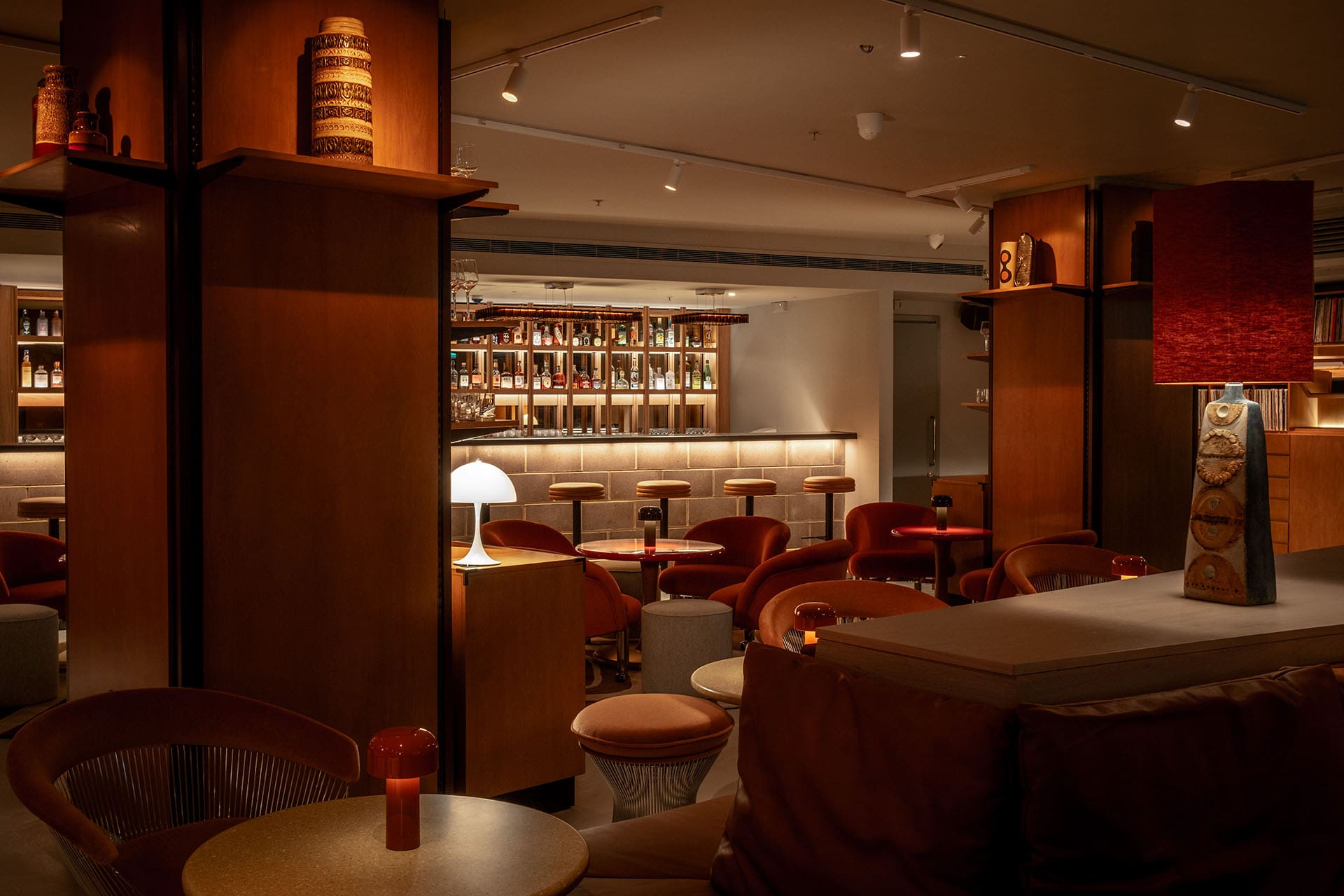 London's best cocktail bars | The bar and stools inside low-lit bar Seed Library inside One Hundred Shoreditch