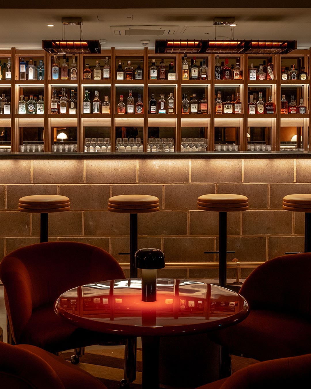 London's best cocktail bars | The bar and stools inside low-lit bar Seed Library inside One Hundred Shoreditch