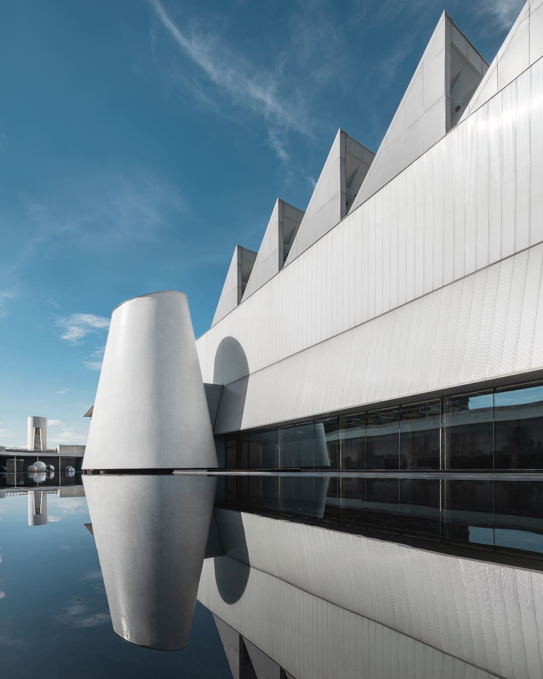 A white industrial exterior beneath a blue sky at DIB Bangkok
