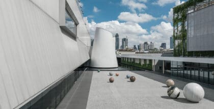 A white industrial exterior beneath a blue sky at DIB Bangkok