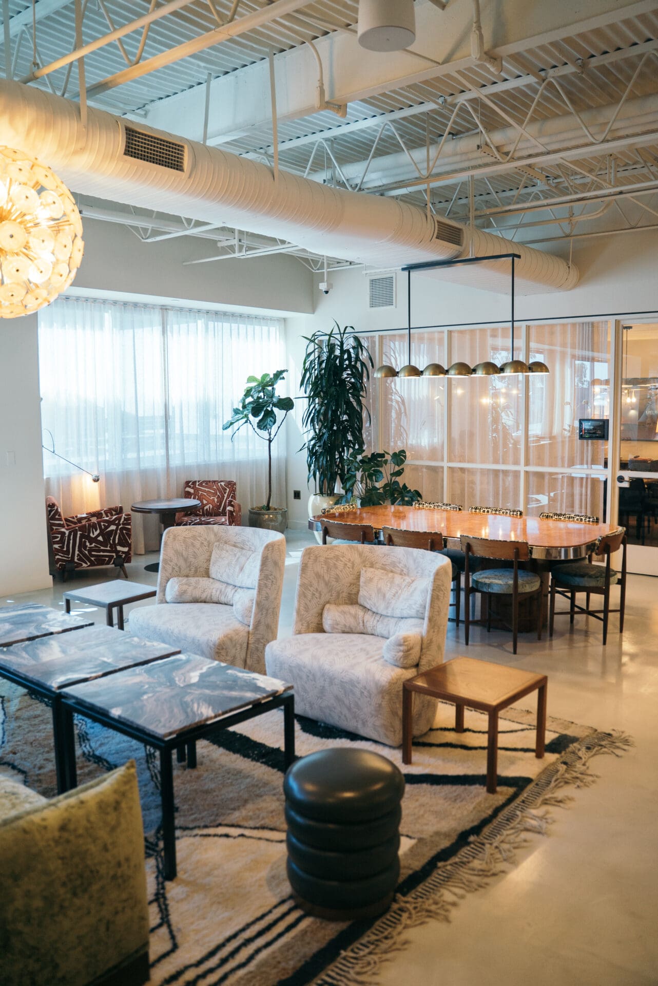 Best places to co-work in LA | An interior view of Soho Works, with arm chairs, tables and rugs