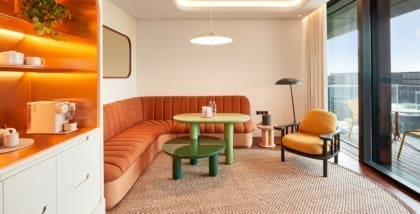 Curvaceous orange furniture by a window at The Standard Bangkok