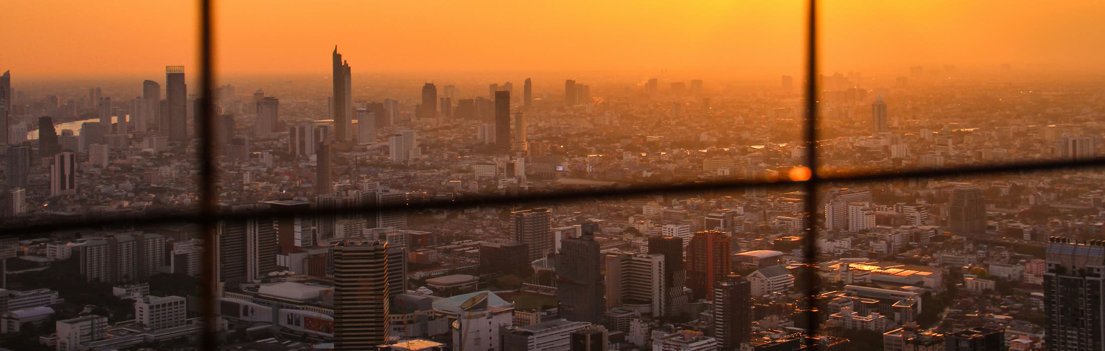 Bangkok's dazzling skyline pictured against a blood-orange sunset
