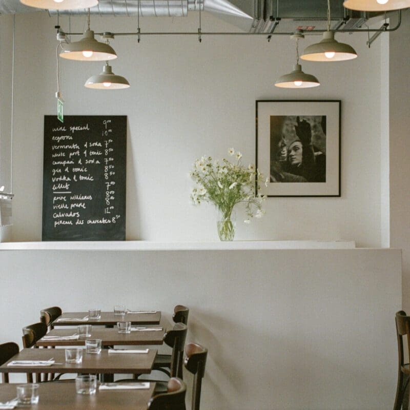 The best restaurants in London | White walls, dark wood and a bunch of daisy-like flowers at Café Cecilia