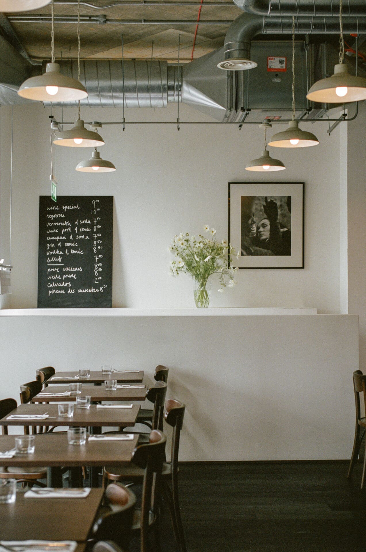 The best restaurants in London | White walls, dark wood and a bunch of daisy-like flowers at Café Cecilia