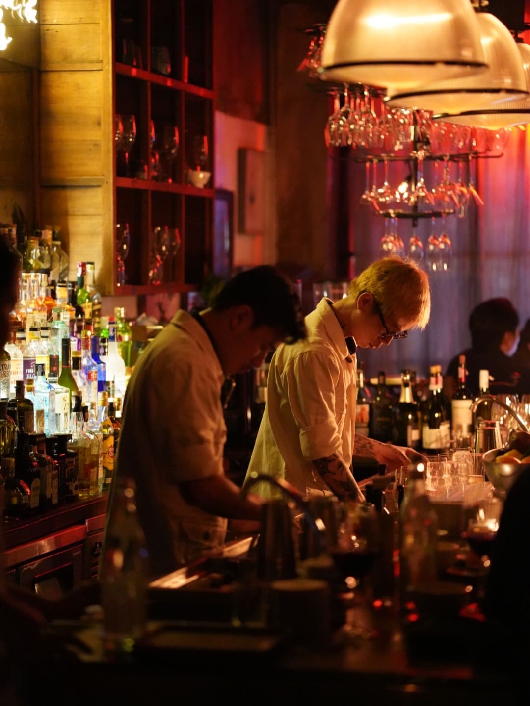 Mixologists behind the bar at Buddha & Pals in Bangkok