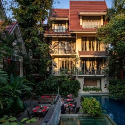 Best hotels in Bangkok | Sunlight falling on gorgeous four-storey hotel Ariyasom Villa and its pool, surrounded by trees
