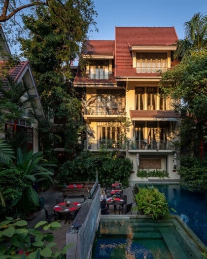 Best hotels in Bangkok | Sunlight falling on gorgeous four-storey hotel Ariyasom Villa and its pool, surrounded by trees