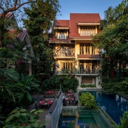Best hotels in Bangkok | Sunlight falling on gorgeous four-storey hotel Ariyasom Villa and its pool, surrounded by trees