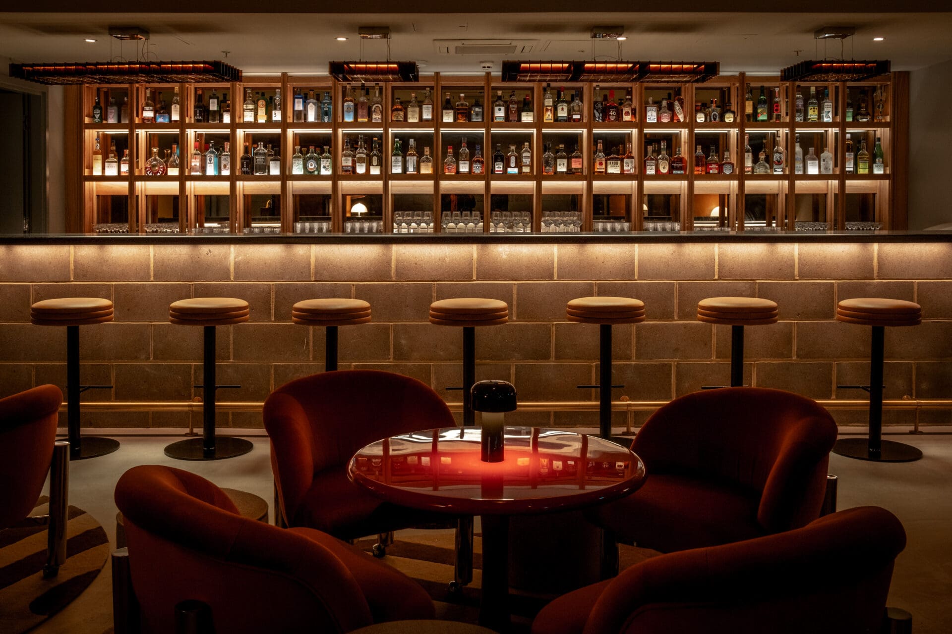 London's best cocktail bars | The bar and stools inside low-lit bar Seed Library inside One Hundred Shoreditch