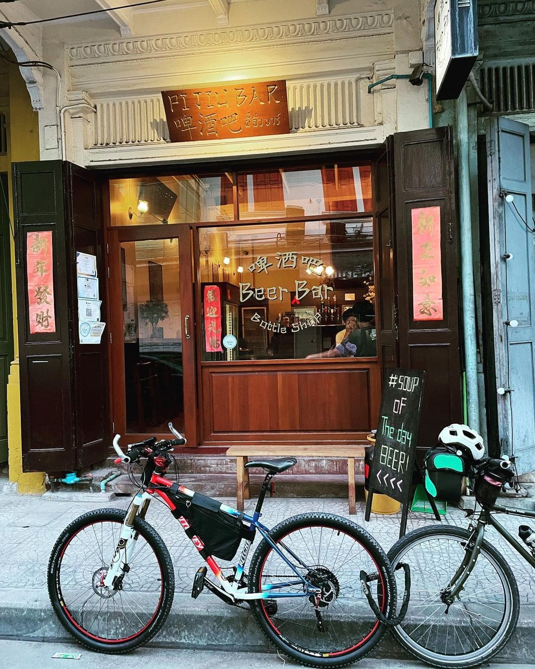 The best bars in Bangkok | the exterior of Pijiu Bar, Bangkok, with bicycles in view