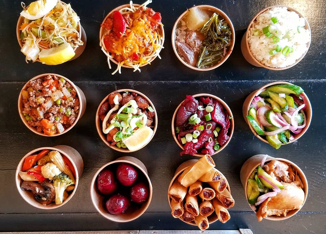 LA's best restaurants | An overhead shot of lunch food pots packed with vibrant ingredients at Big Boi in LA