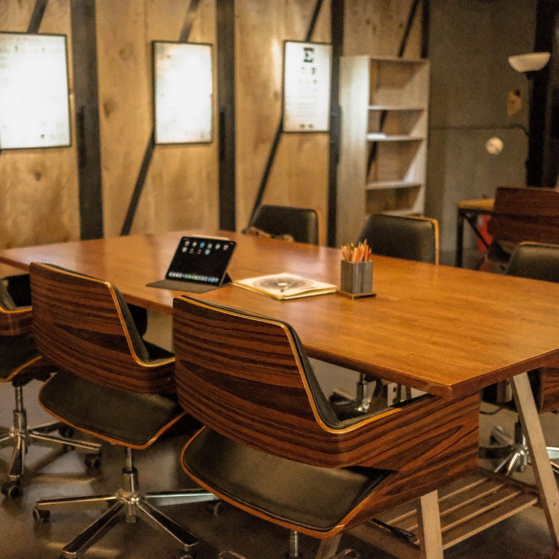 Where to co-work Bangkok | Seventies-style dark-wood chairs and a wooden desk at Draftboard