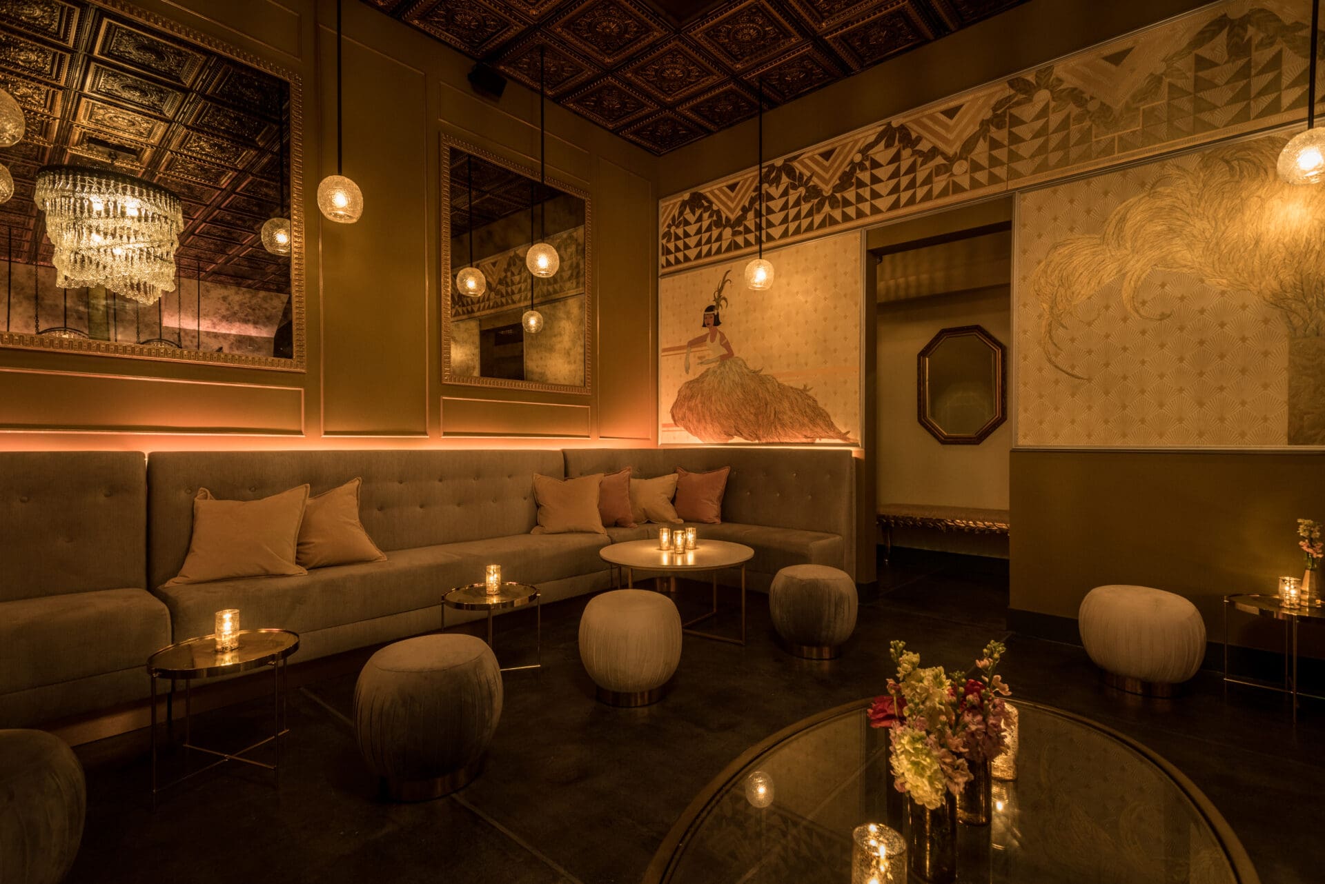 LA's best cocktail bar | A golden-hued low-lit room with low tables and stools and plush sofas at LA cocktail bar Genever
