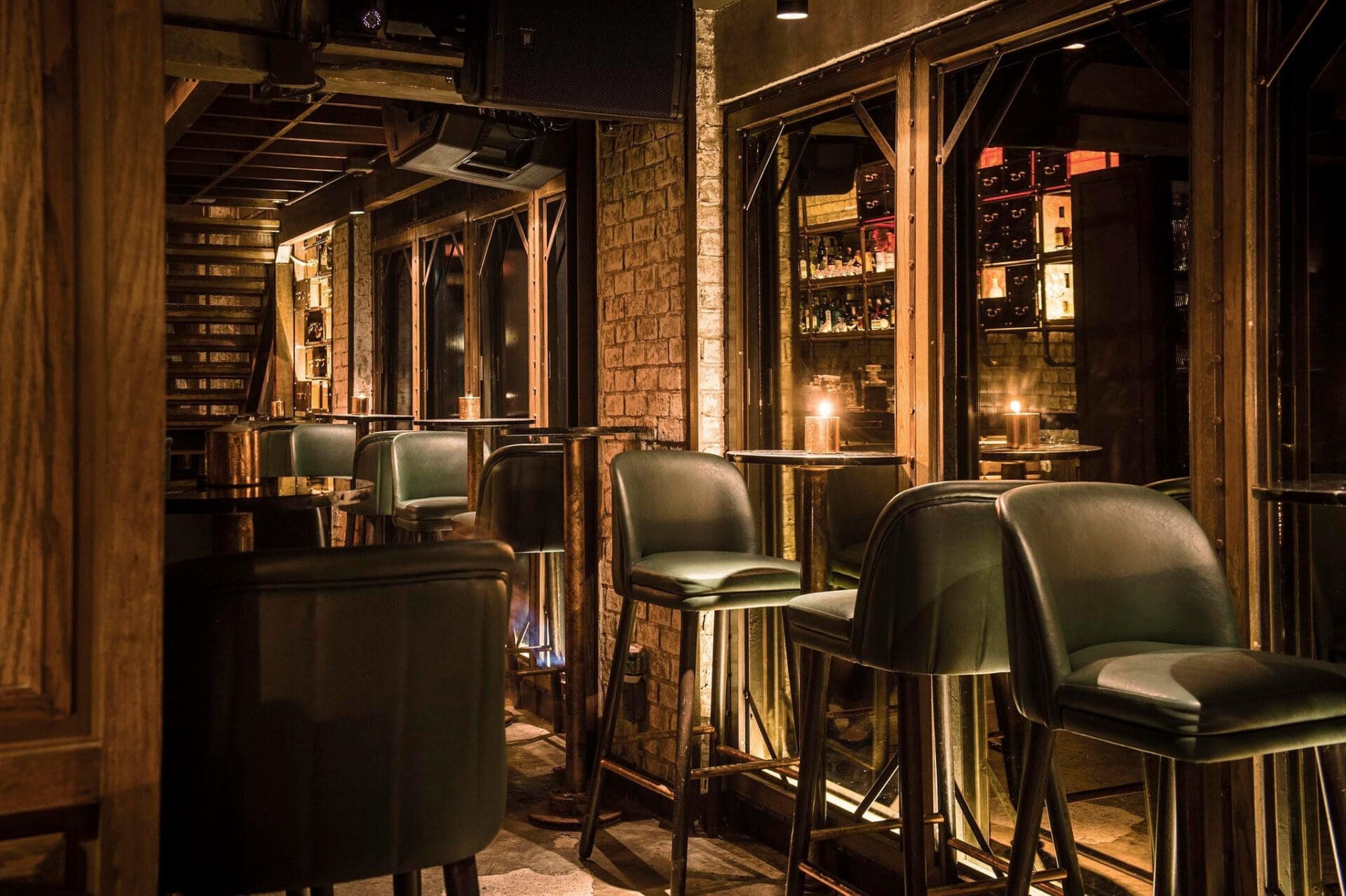 Bangkok's best bars | Leather high chairs and mirrors at Rabbit Hole bar