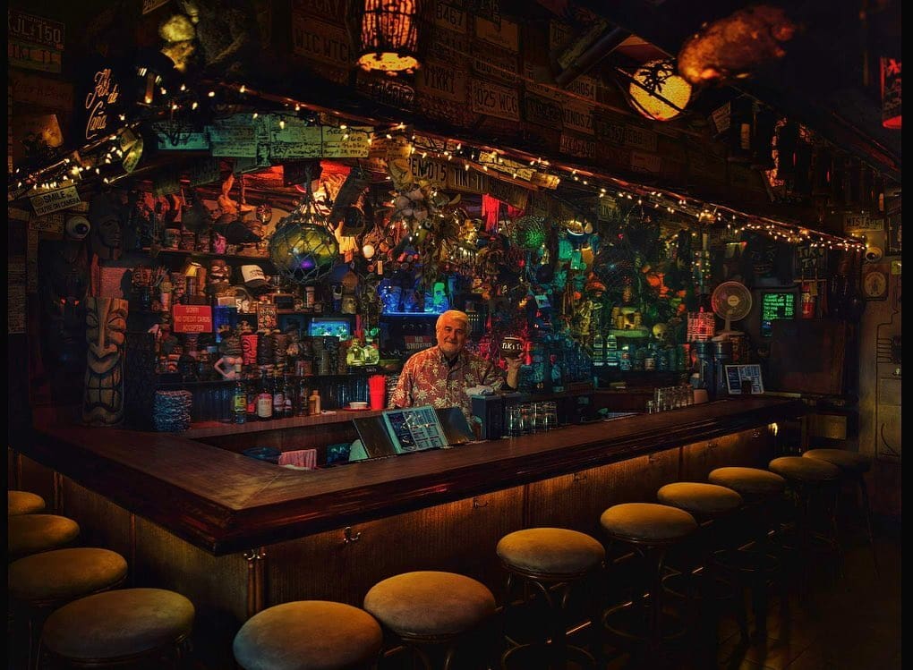 A man behind an embellished bar at Family-run Tiki Ti