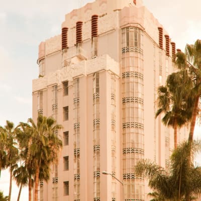 The best cocktail bars in LA | A shot of Sunset Tower Hotel on Sunset Boulevard, flanked by palm trees