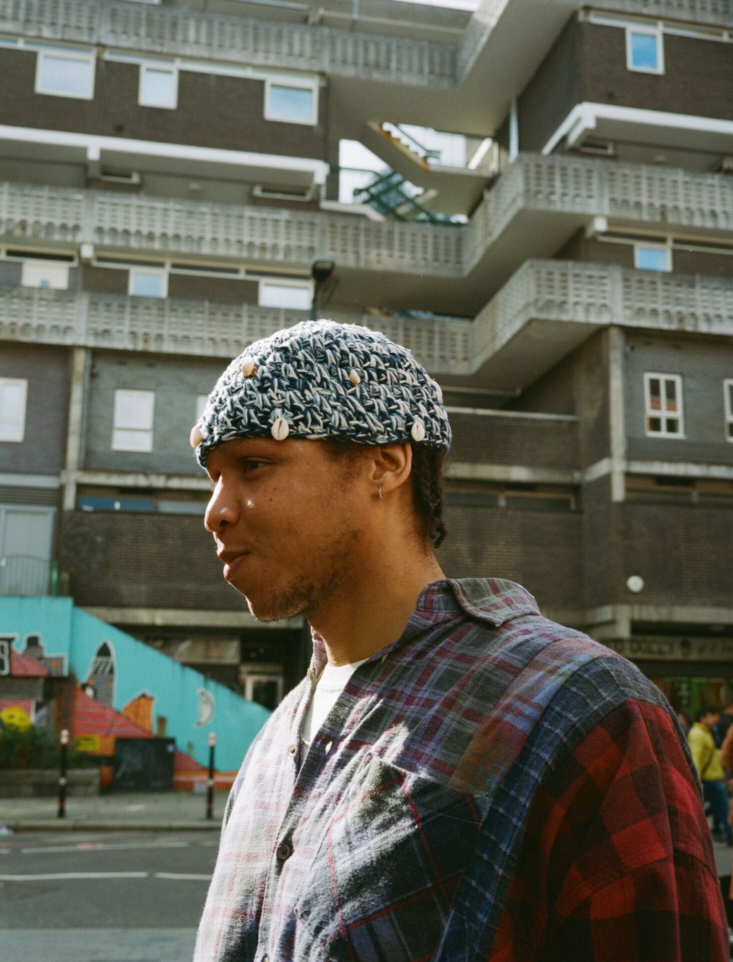 Taylor Simmons | a side profile shot of the artist standing outside in Aldgate, London. Photo by Sophie Davidson