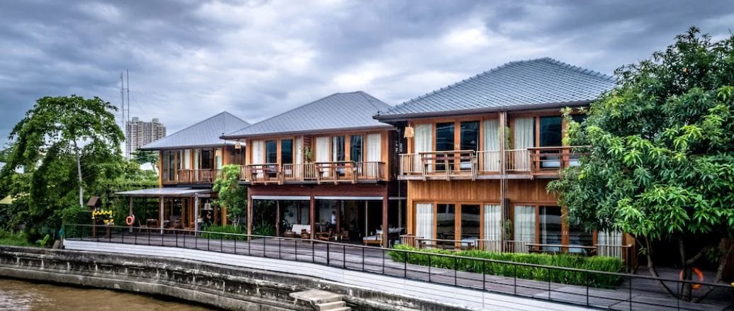 Where to stay in Bangkok | Riverside villas at Chann, with wooden buildings with balconies overlooking the water