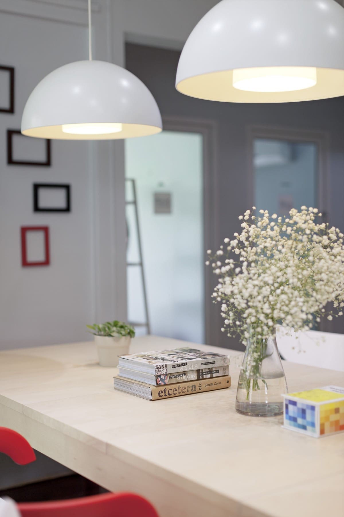 Bangkok's best places to co-work | a desk area with concrete worktop, wildflower bouquet and semi-circular overhead lighting at Muchroom