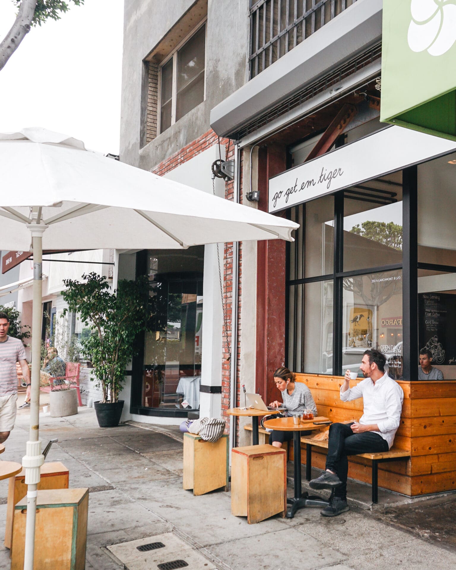 Best coffee shops in Los Angeles: two people sitting outside Go Get Em Tiger.