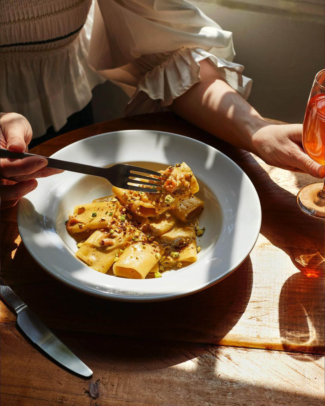 A person eating a bowl of pasta at Darling's near Hackney Wick