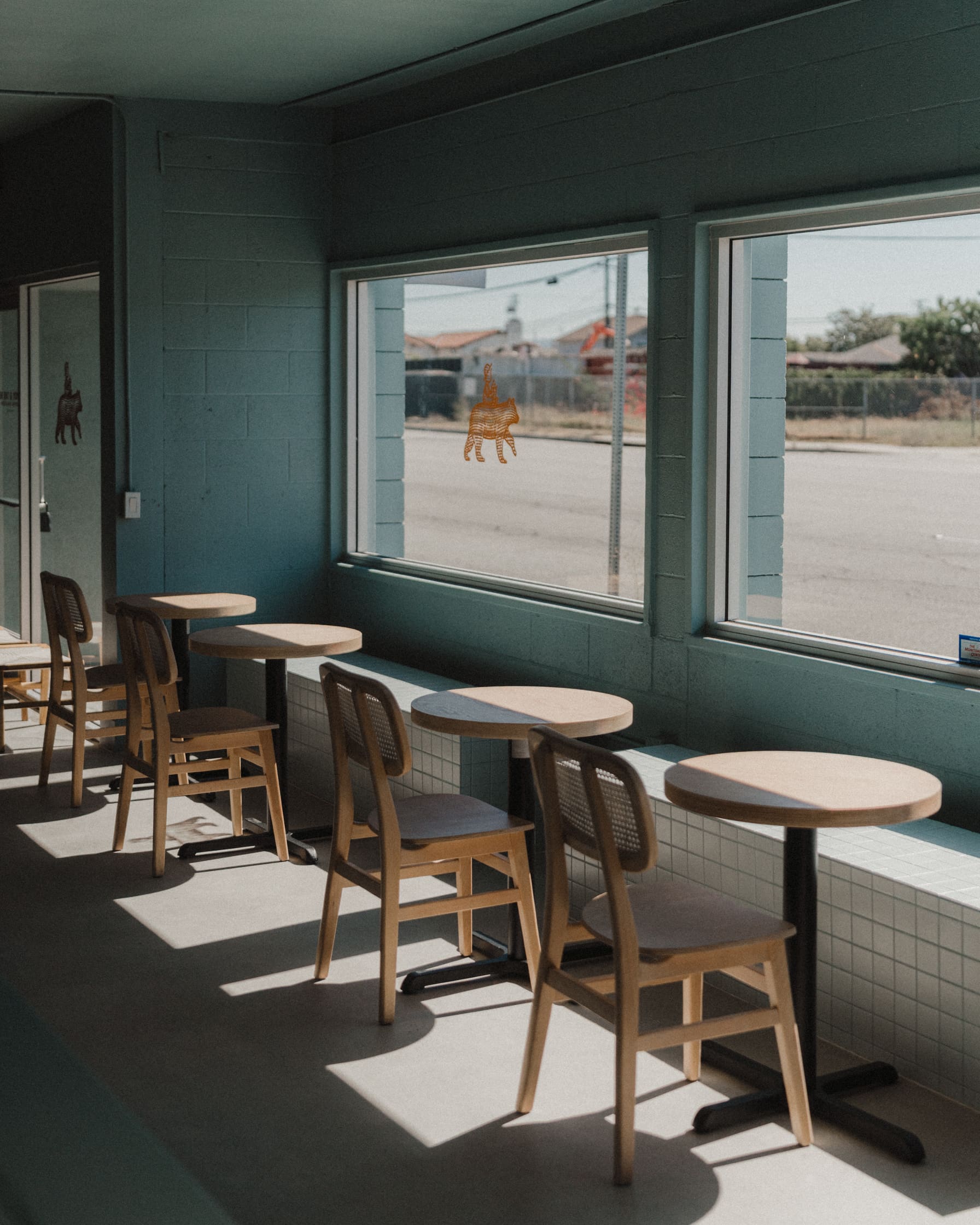 Tables by the window at The Boy and the Bear in Los Angeles