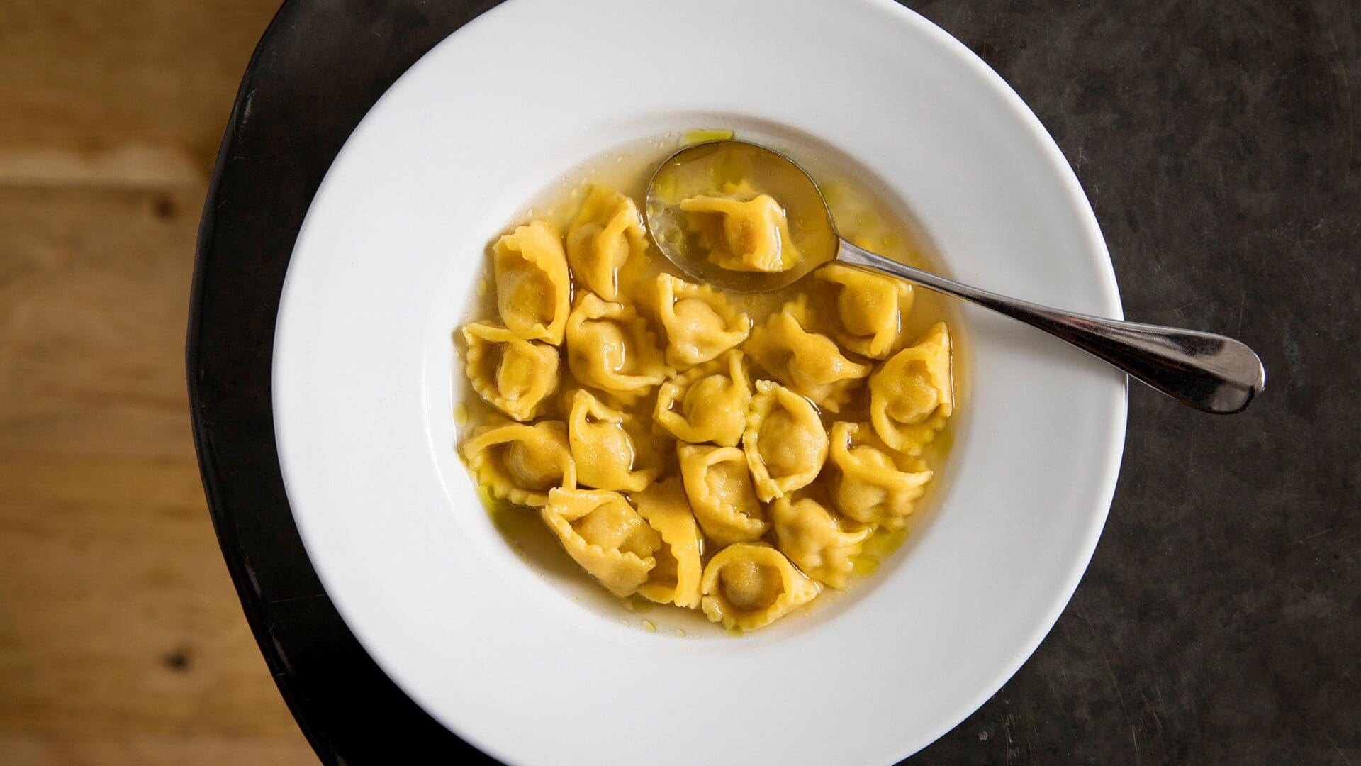 The best restaurants in Hackney | A plate of tortellini in broth, on a wooden table, at Brawn