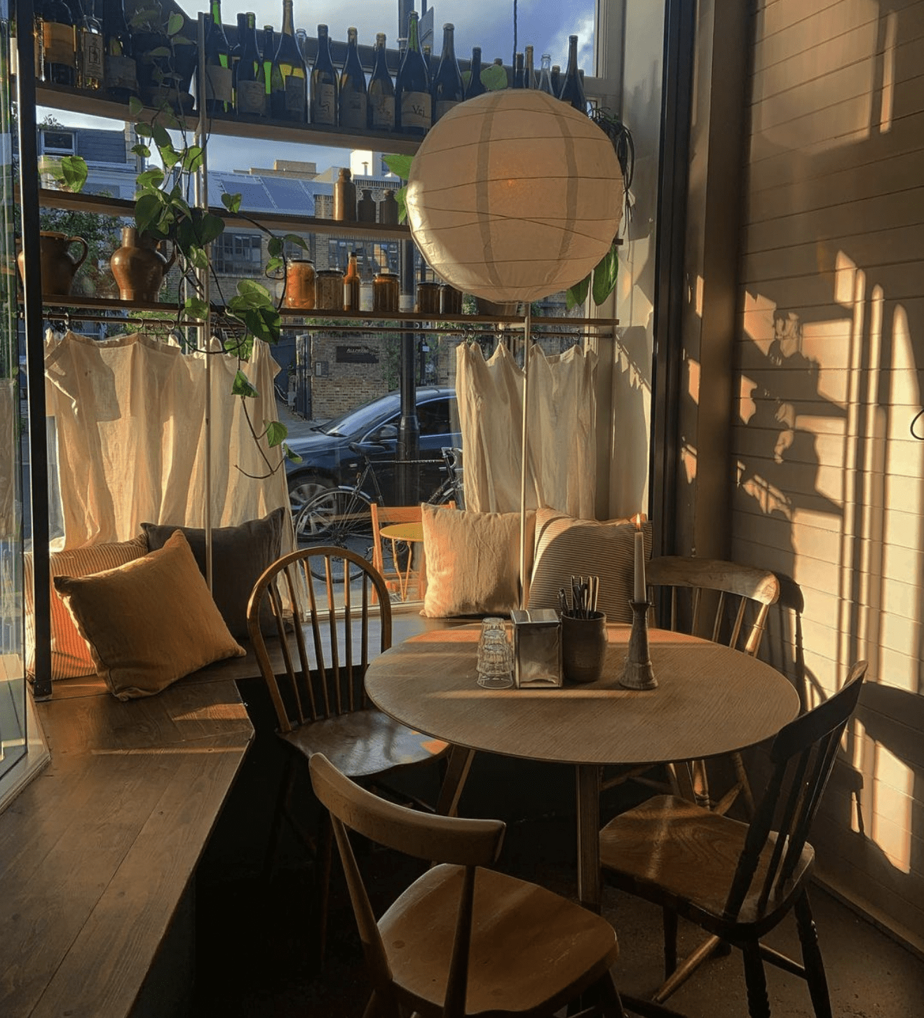 The best restaurants in Hackney | A paper lantern hangs over a circular table with four chairs in a window corner at Little Duck The Picklery