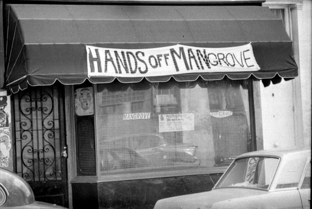 London's Caribbean community | a sign reading "Hands off Mangrove" above the Caribbean Mangrove restaurant