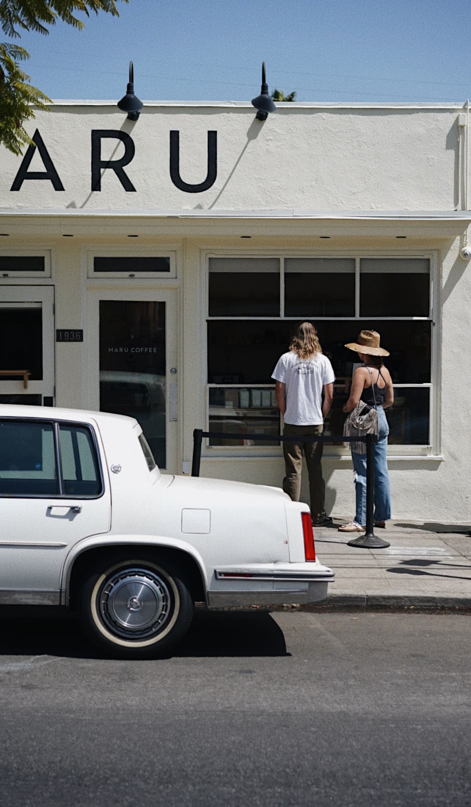 A car parked outside Maru coffee in Los Angeles on a sunny day