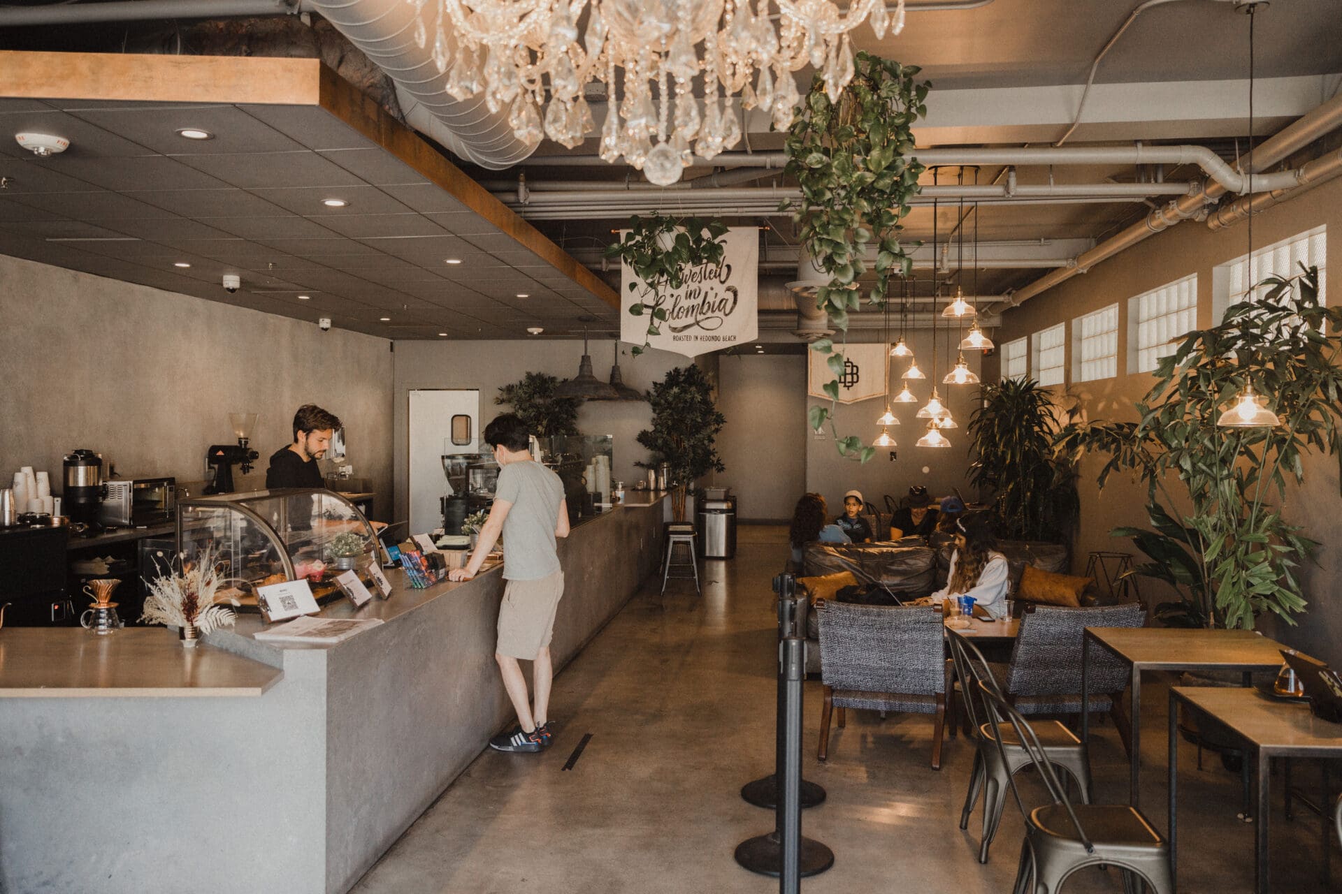 LA's best coffee shops | The interior at The Boy and the Bear, with grey concrete counter, grey concrete flooring and grey-accented furniture