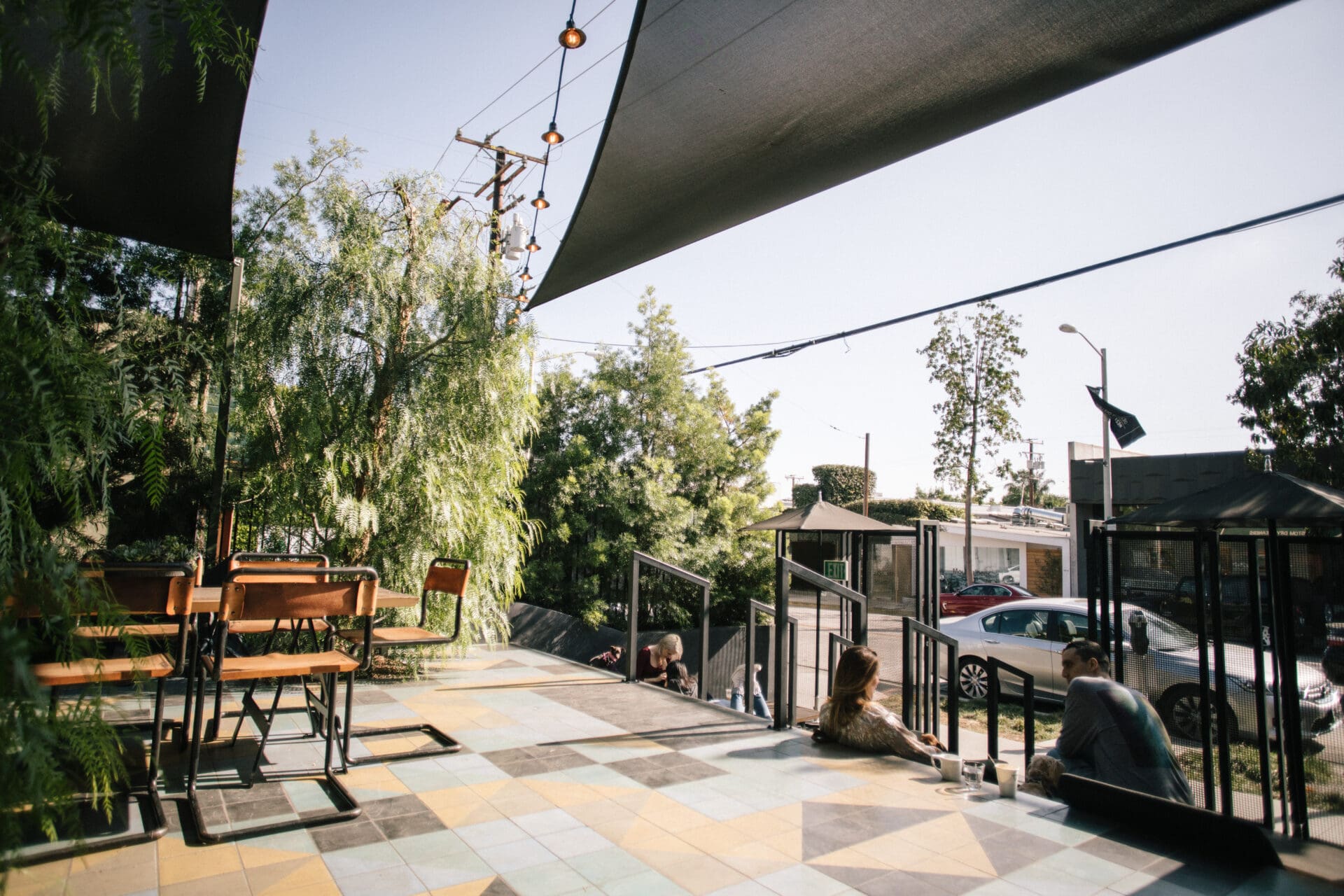 LA's best coffee shops | The terrace outside Verve's Melrose site, with a stone-tiled floor, wooden furniture and plenty of plants underneath an awning in the LA sunshine