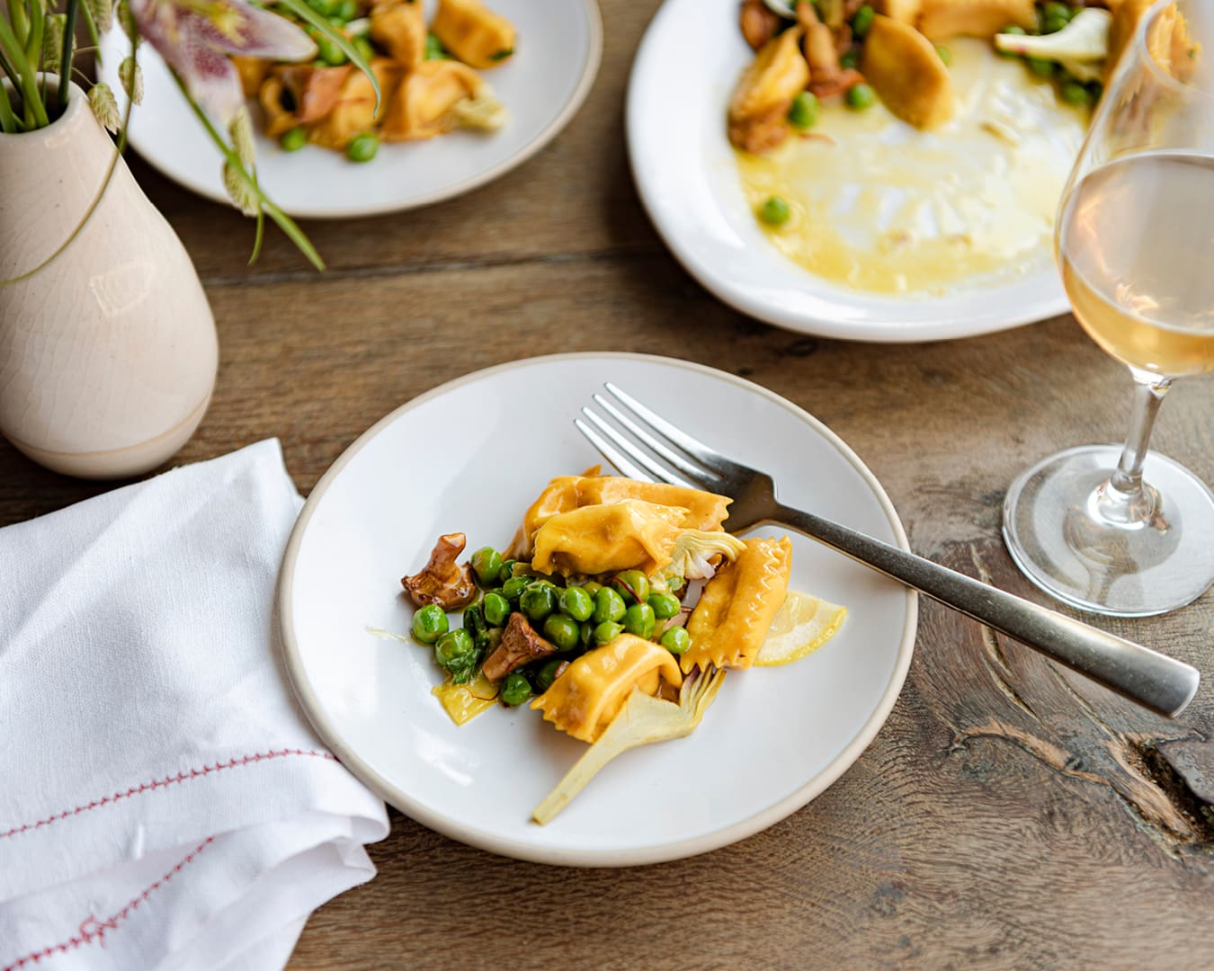 Fresh ricotta agnolotti pasta with a glass of white wine at Wildflowers in Belgravia