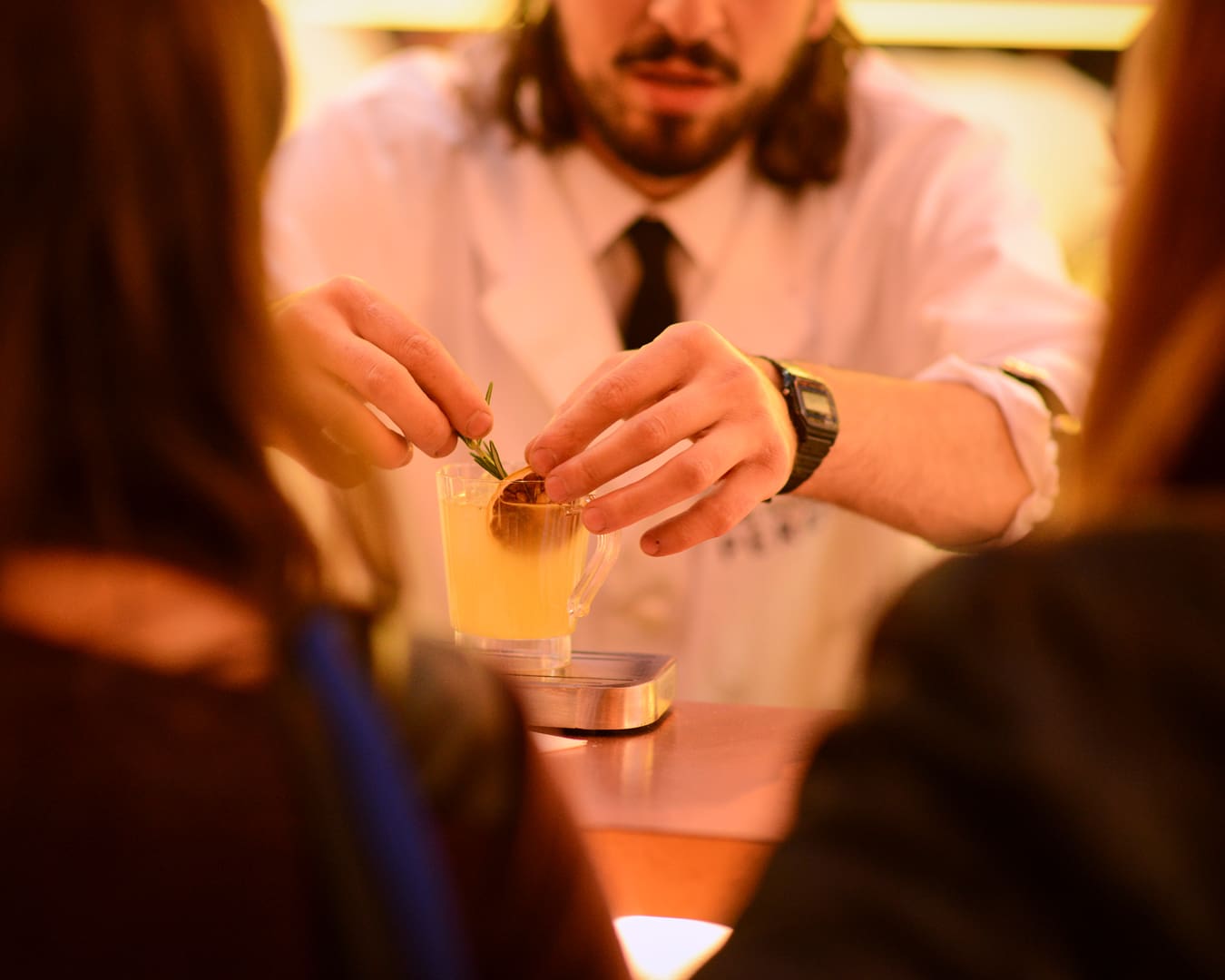 A bartender garnishes a cocktail at London Cocktail Week