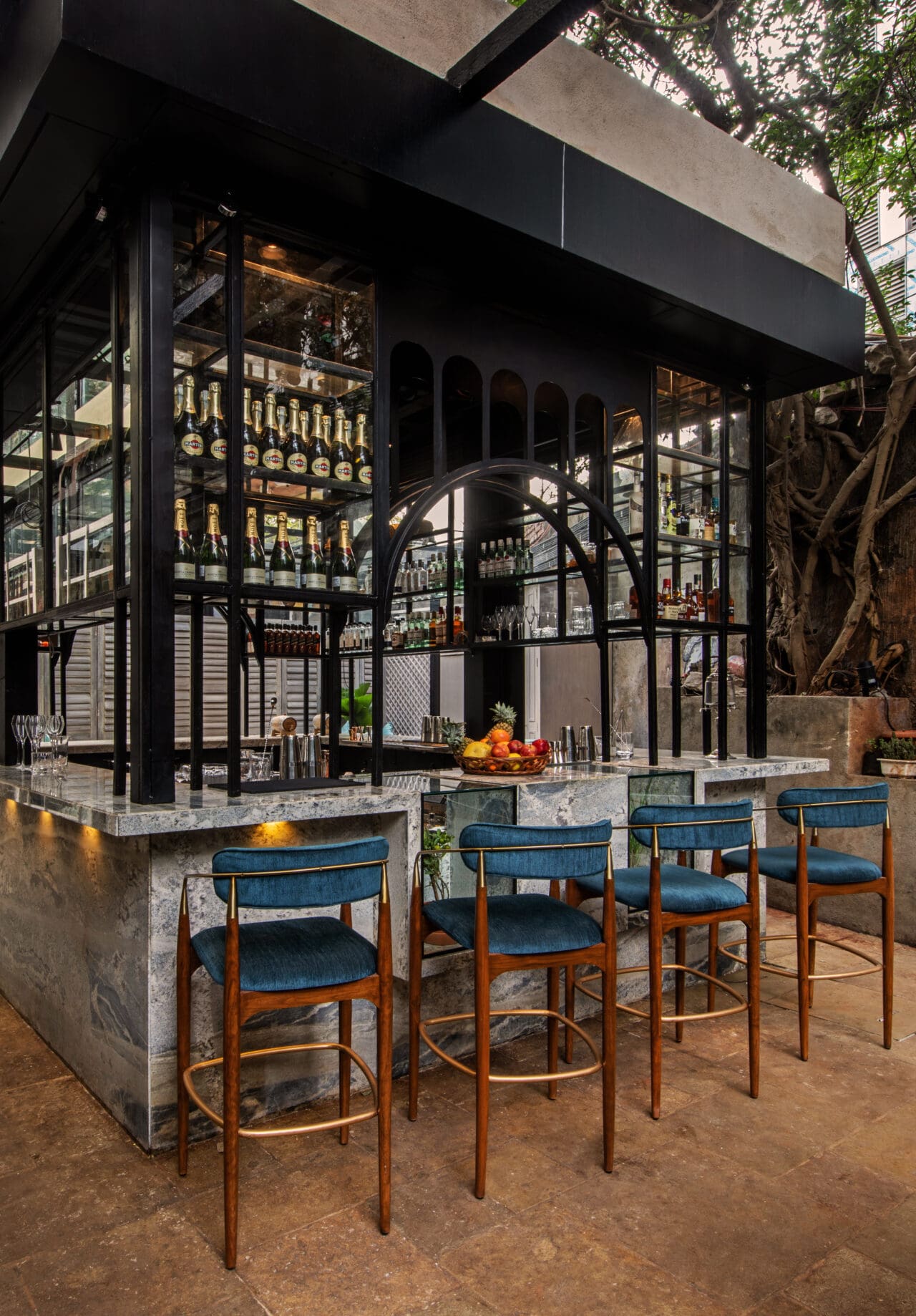 Best bars in Mumbai | an outdoor marble bar lined with high stools at PCO in Mumbai