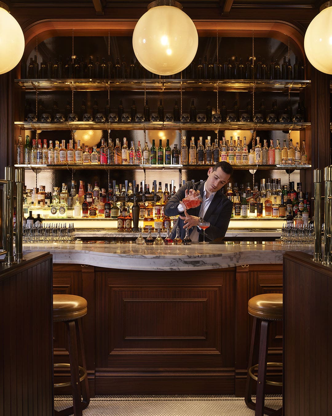 A mixologist at work at Side Hustle within NoMad Hotel