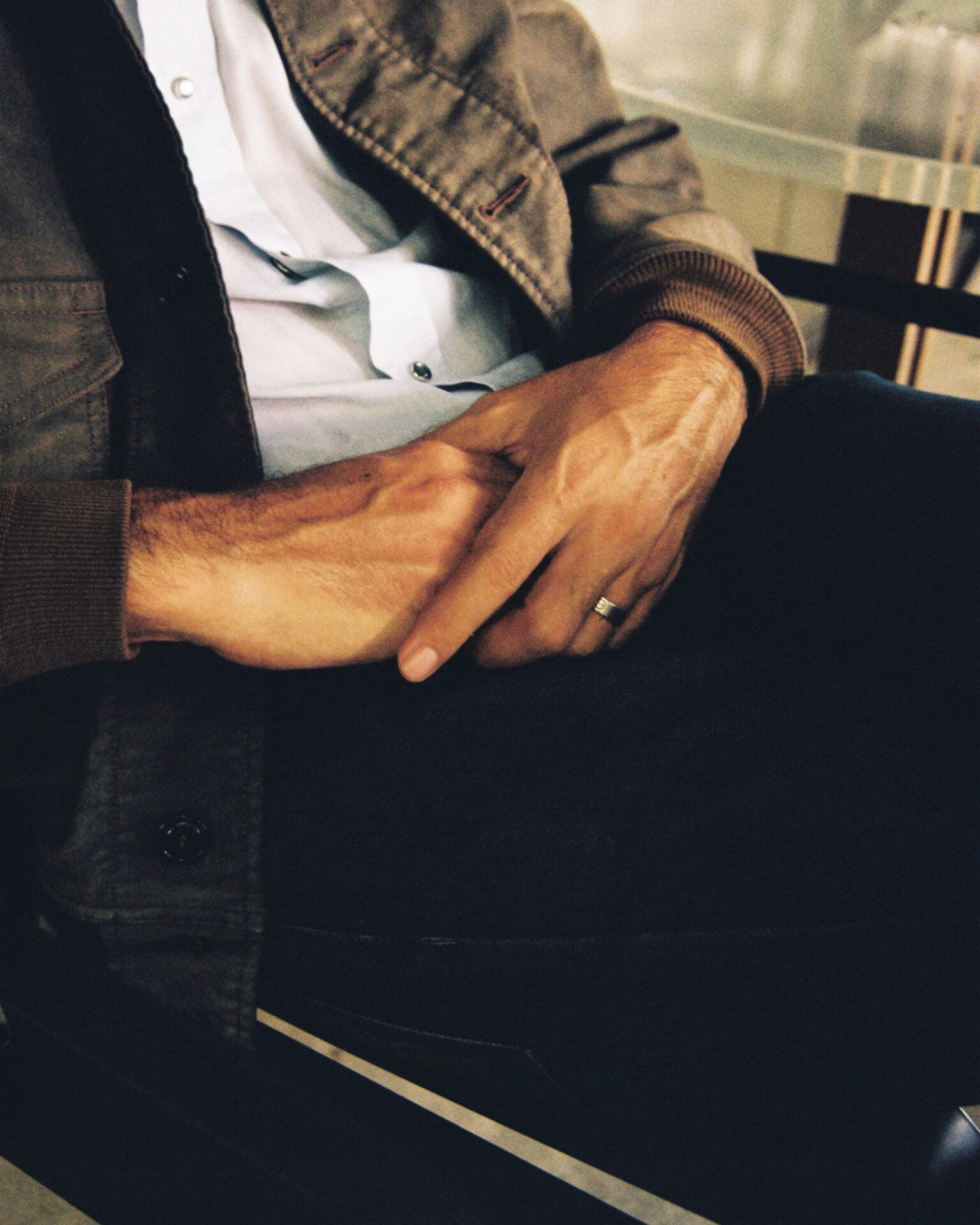 An interview with Hugo Chakrabongse | the artist's hands with a wedding ring, clasped in his lap