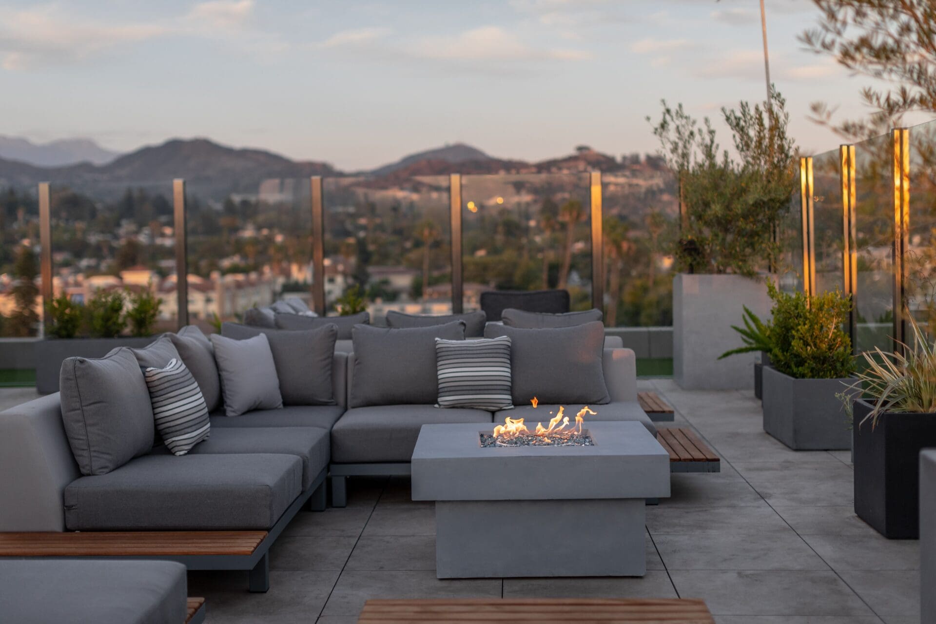 a fire pit and seats overlooking Los Angeles from MYA Rooftop at the Glenmark