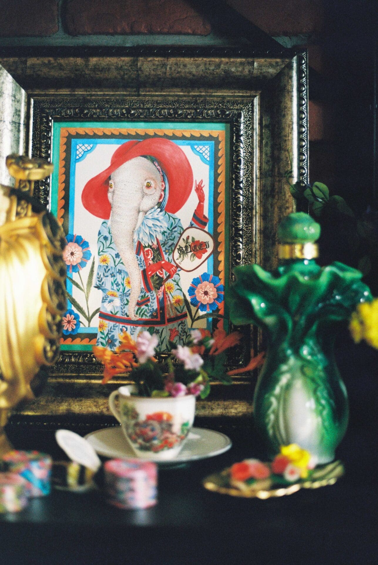 Phannapast | More ornaments in her studio, with a drawing in a frame, a tiny cup and saucer and a gold vase