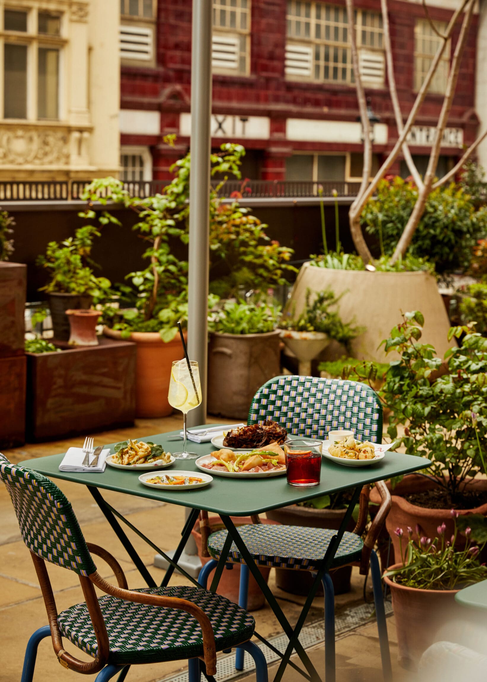 The best outdoor restaurants in London | A plant-framed table at Toklas restaurant in the Strand