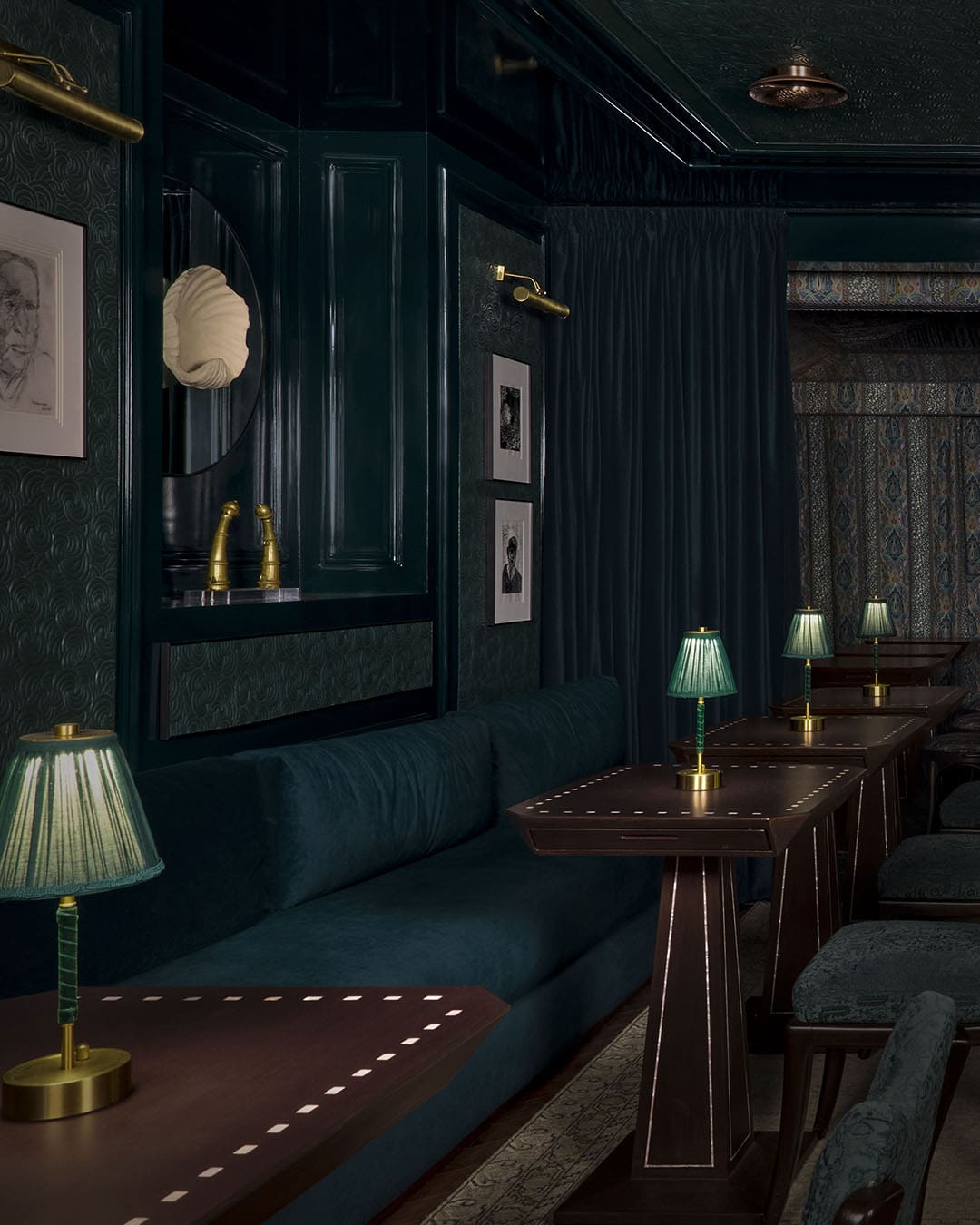 The low-lit green and blue dining room at Bar Paradox