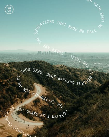 Hiking in LA | a road through the hills outside LA on a sunny day, with a view over the city in the distance